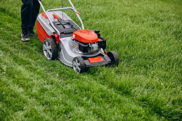 man-cutting-grass-with-lawn-mover-back-yard (1)